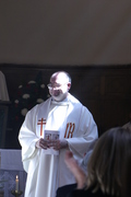 Fr Gareth smiles as the congregation applauds.